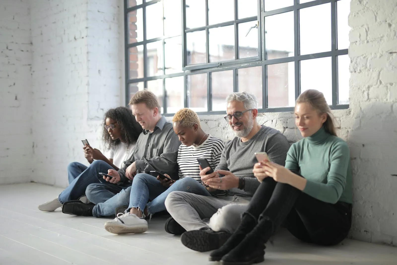 Diverse group of people connected through their phones