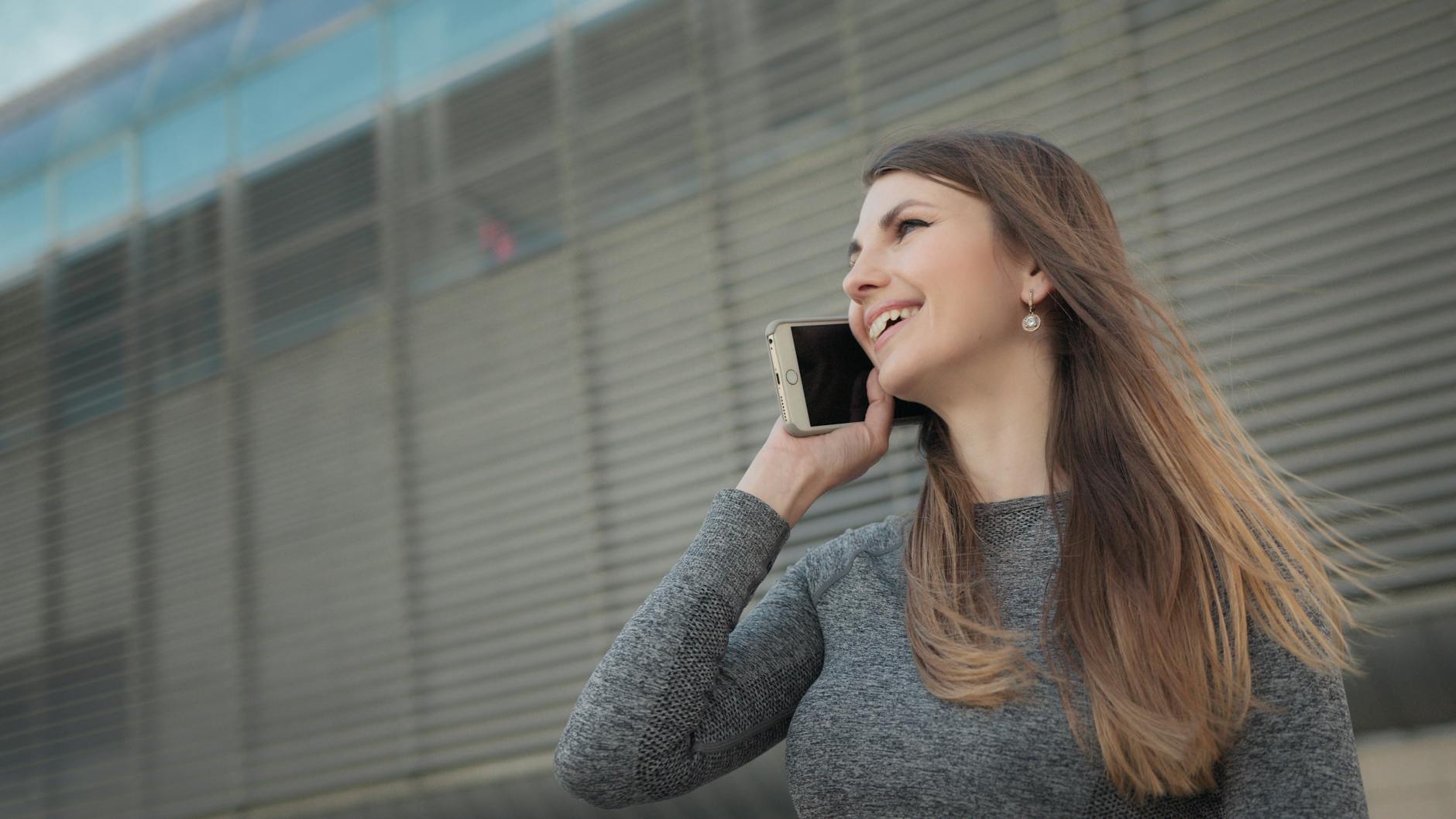Woman laughing while talking on the phone